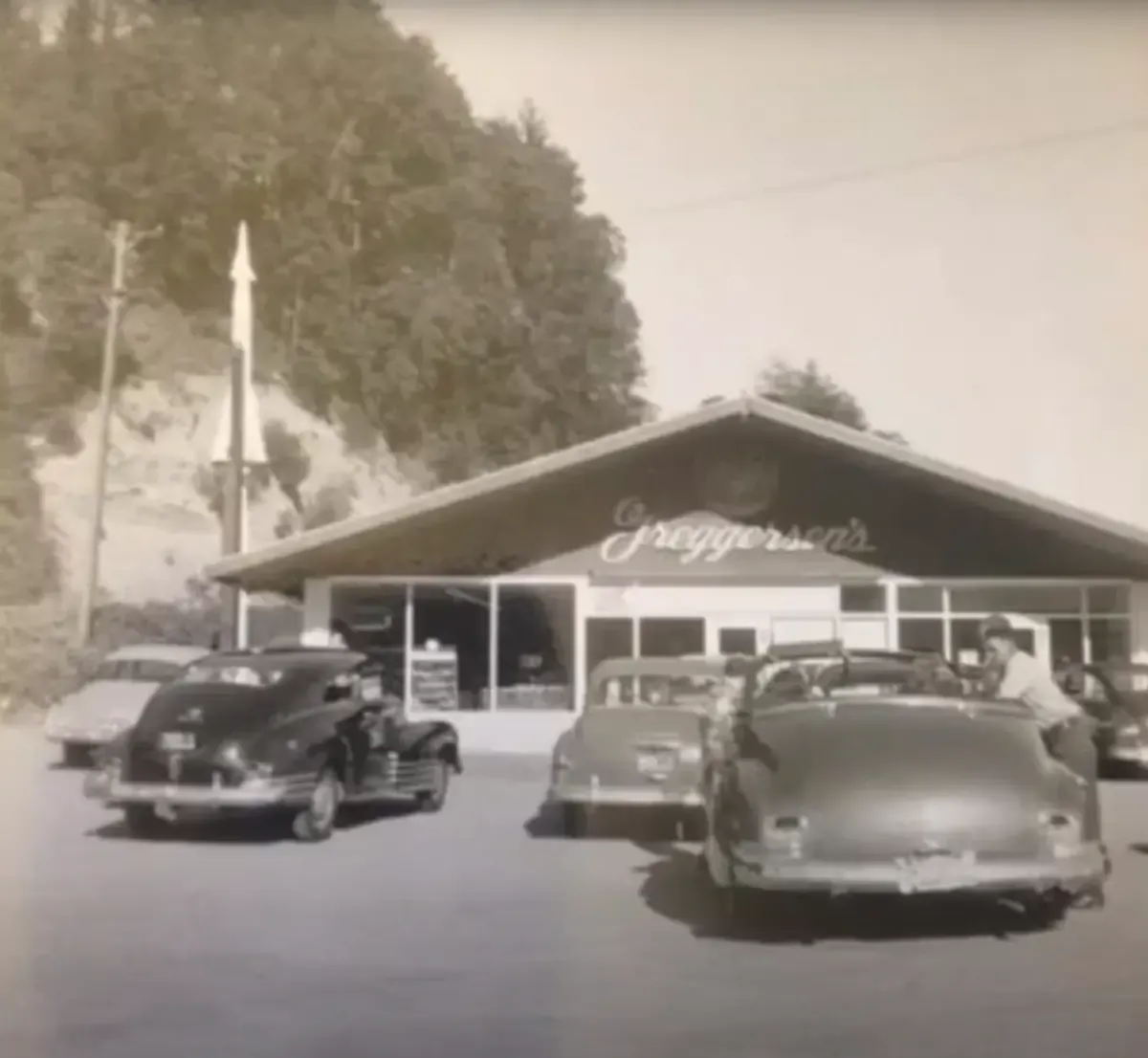 Greggersen's, a low gabled building with a script sign, and 1940s cars parked out front