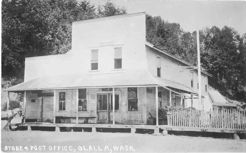 Old postcard of a two-story wooden building captioned Store and Post Office, Olalla, Wash.